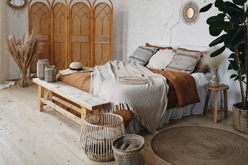 A warmly decorated rental apartment with removable decor, layered rugs, plants, and soft lighting.